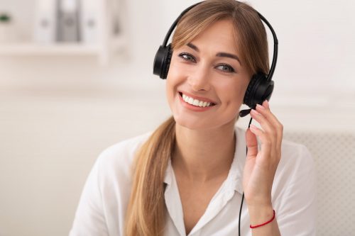 Smiling Woman In Headset Working In Call Center Office